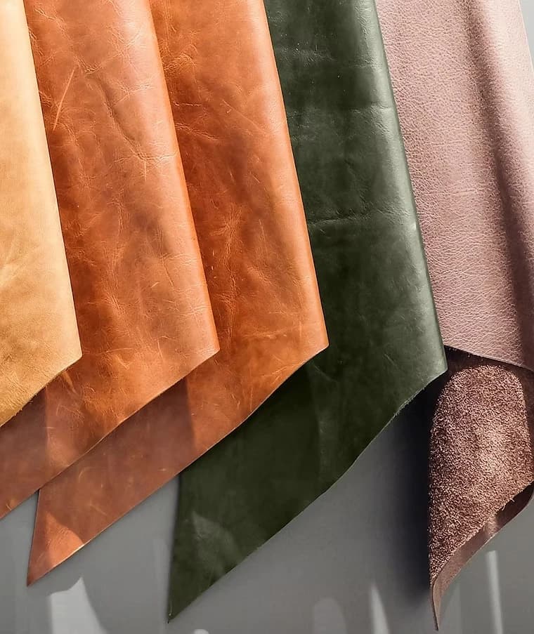 Muestras de tela apiladas en tonos naranja, verde oliva y café